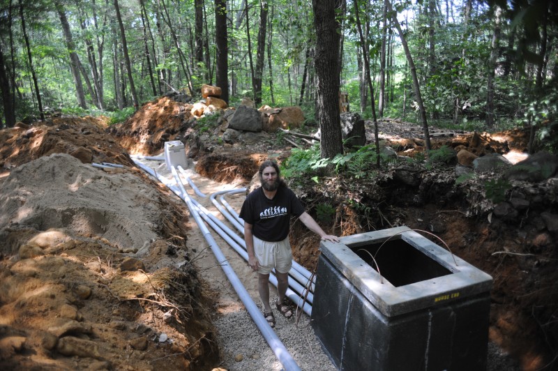 [Separate conduit was laid for electrical power and data transmission. Site PI Aaron Ellison is shown here next to the new 8 kVa transformer.]