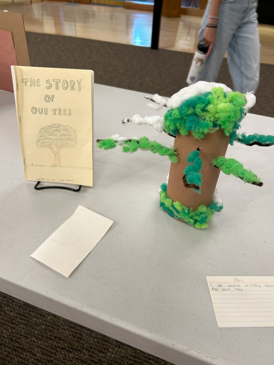 Image shows a tree crafted by a student alongside a handmade book entitled "The Story of Our Tree." Image by student Ava Rubin.