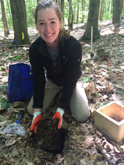 Summer program student taking a soil sample