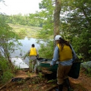 [Taking a canoe out on the water to collect Pitcher Plants.]